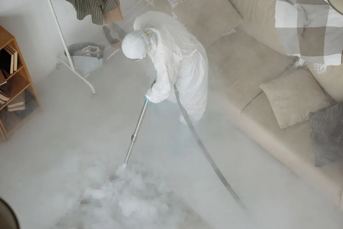 Biohazard cleanup technician in protective equipment, Frontenac, KS